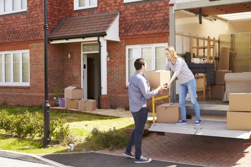 Removal team loading furniture into a van