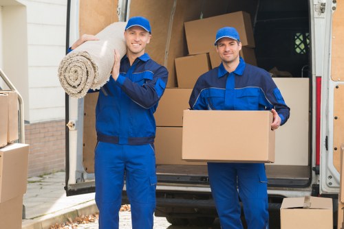 Removal team loading furniture safely with protective equipment