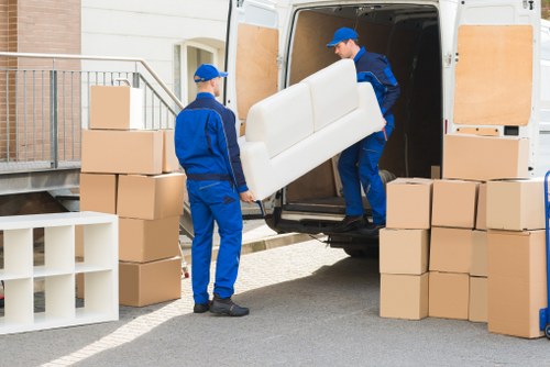 A removal van parked on a London street near an apartment block